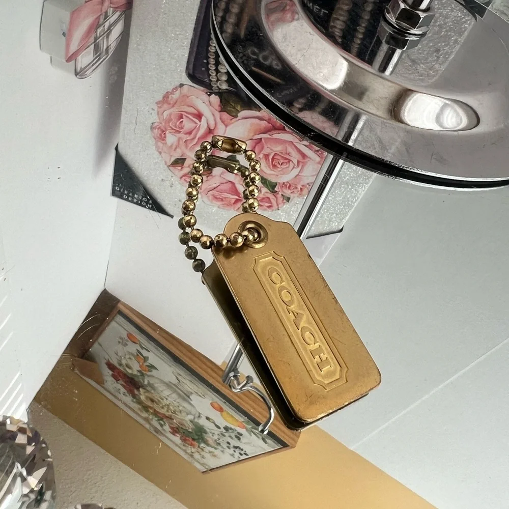 Coach color brass  metal tag
